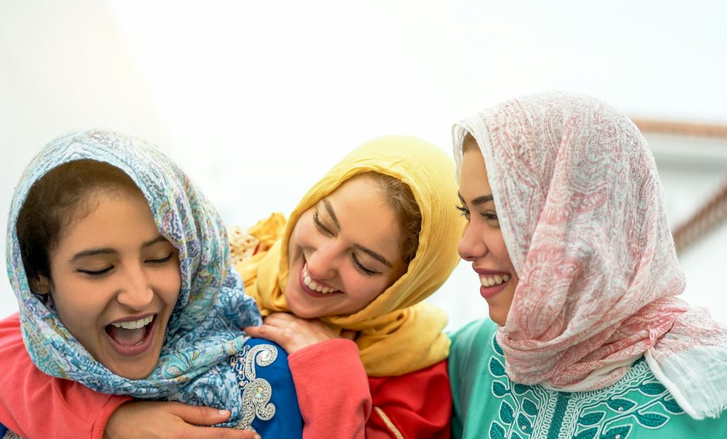 Happy arabian women having fun in the city