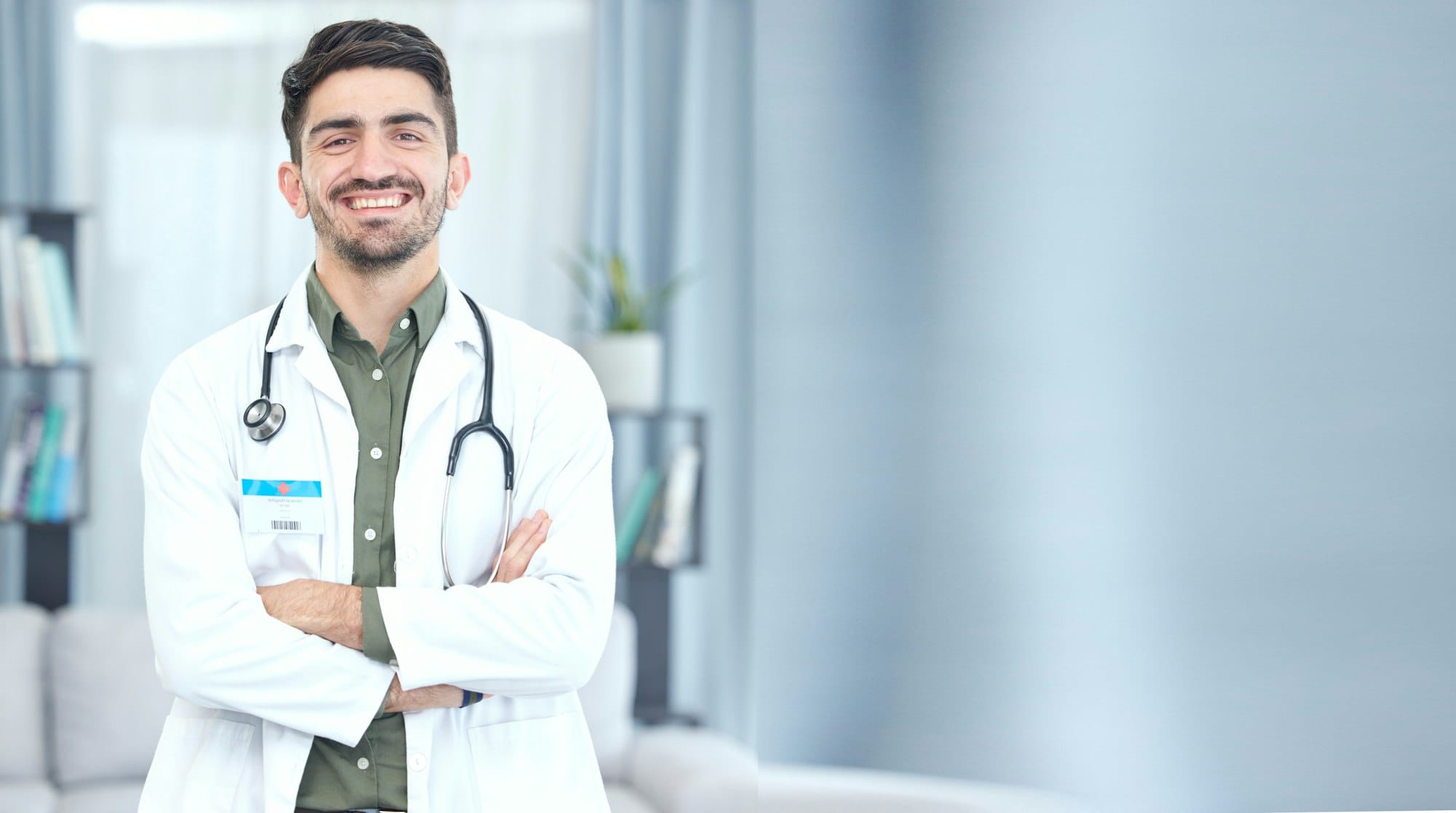 Doctor, man and portrait with arms crossed for healthcare, hospital services and support on banner
